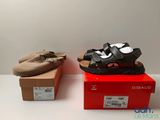 two pairs of shoes are sitting on a box next to each other