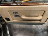 the interior of a car with the door open and the door handle open