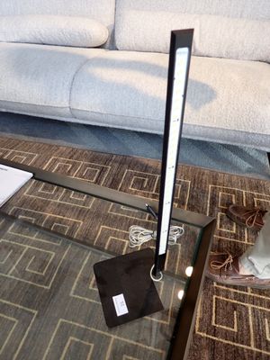 une table en verre sur laquelle est posée une lampe, dans un salon