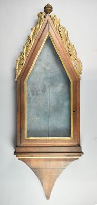 a wooden frame with a mirror on it on the wall
