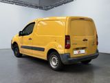 the yellow van is parked in the large room of the building
