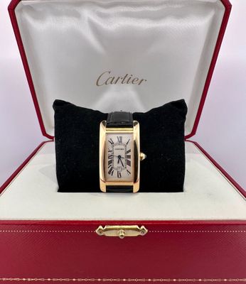 a cartier watch in a red box on a white surface