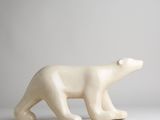 white ceramic sculpture of a polar bear on a grey background
