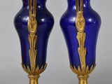 pair of blue and gold vases sitting on top of a table