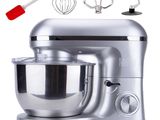 a silver mixer with a red spatula next to it