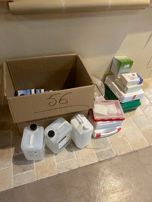 a cardboard box on the floor next to a box of toilet paper