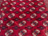a red rug with a medallion design on the bottom of it