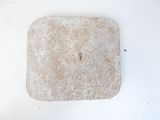 a small square stone on a white surface