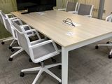 tables and chairs in a conference room with a flat screen tv on the wall