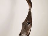 an image of a sculpture of a bird head on a pedestal