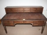 a wooden desk with a drawer on top of it