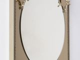 a mirror on the wall with two lamps on it