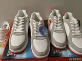 three pairs of white and red sneakers sitting on top of a box