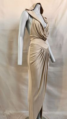 an image of a mannequin wearing a beige dress on a mannequin stand