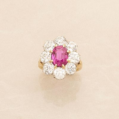 an oval ruby and diamond cluster ring
