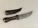 two knives that are sitting next to each other on a table