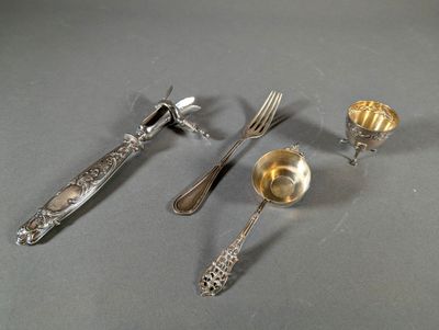 silverware on a table with a knife, fork, spoon, and spoon rest