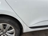 a close up of a white car with a flat tire