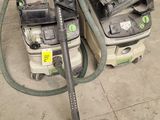 two vacuums that are sitting on the floor next to each other