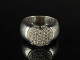 a close up of a silver ring with a heart on it