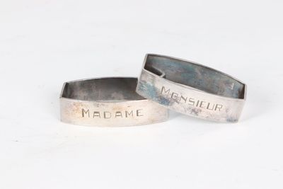 two silver rings with the names of men and women on them