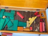 a wooden box filled with wooden blocks and pieces of wood