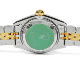 an image of a watch with a green dial on a bracelet