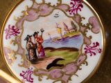 a gold plate with a picture of a woman and a dog on it