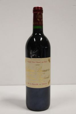 the bottle of red wine is sitting on the table