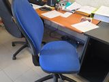 a desk with a chair and a computer on it
