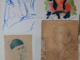 several different colored drawings on a white wall with a woman in the background