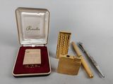 a small box with a lighter and a pen in it