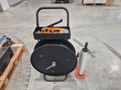 an image of a black and orange machine in a warehouse