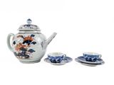 two cups and a teapot sitting on a table