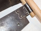 a close up of a pair of saws with a wooden handle