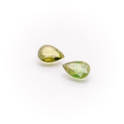a pair of green tourmaline gems on a white background