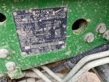 a close up of a green motorcycle with a number plate on it