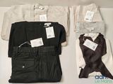 three pairs of pants and a shirt with tags on them