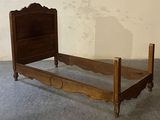 a bed with a wooden headboard and foot board