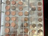 a lot of coins in a plastic container on a table