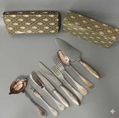 un service d'argenterie sur une table à côté d'une boîte