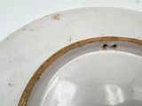 a white toilet with a brown rim and a brown handle