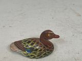 a small duck that is sitting on the floor