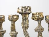 five candles that are standing in a row on a table