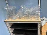 a lot of plastic containers sitting on top of a shelf