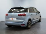 the rear of a blue citrole parked in a white room