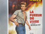 movie poster of a man in jeans standing in front of a fire