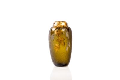 a glass vase that is sitting on a white surface