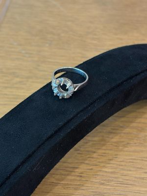 an image of a diamond ring sitting on top of a black case