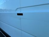 a white van that is parked on the side of the road